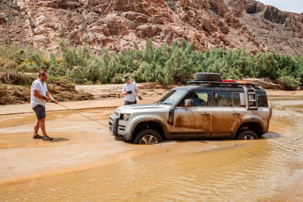 Driving the 2020 Land Rover Defender proves it's ready to conquer the world again_wading in a river_Hagerty_winching out of a river