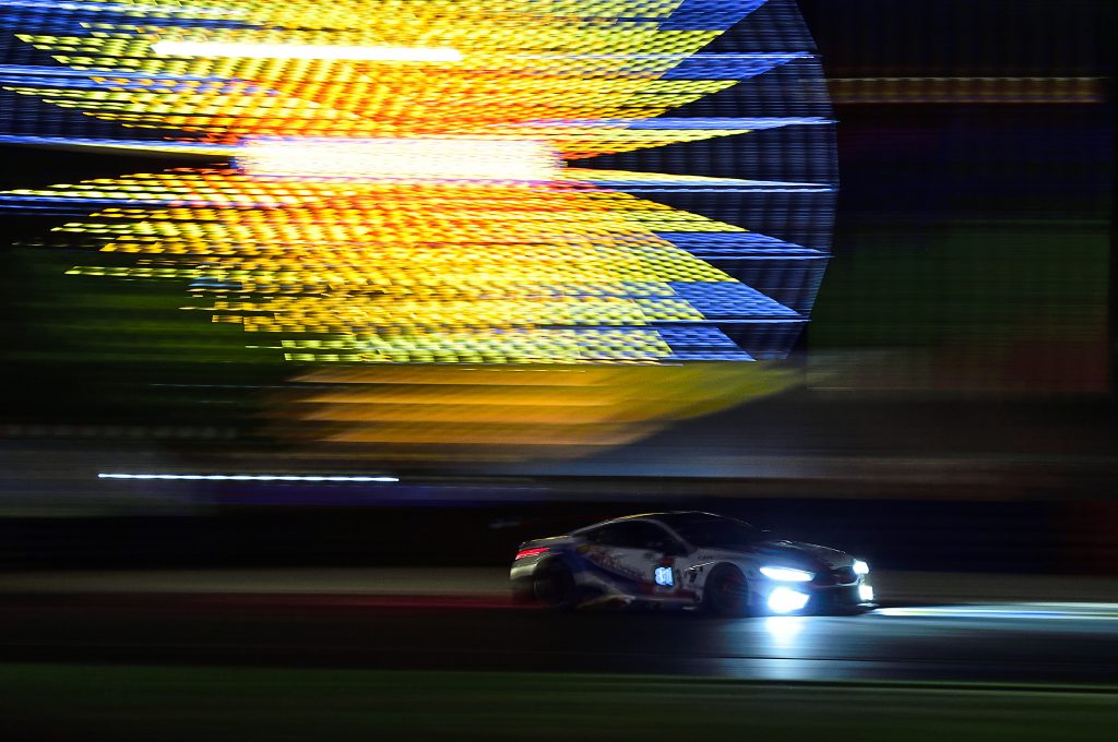 A BMW M8 GTE races past the ferris wheel at Le Mans