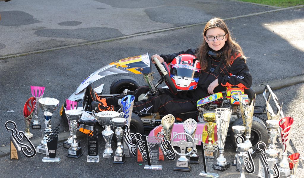 Catherine Potter with karting trophies