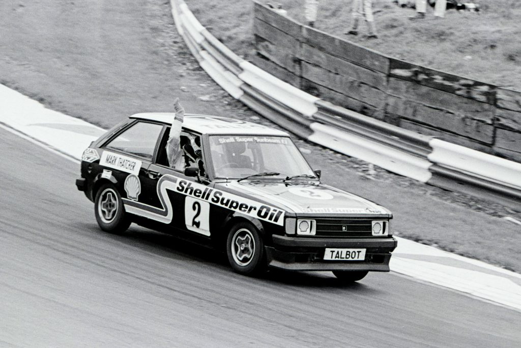 Mark Thatcher waves to the crowds after finishing the 1980 Lords v Commons race