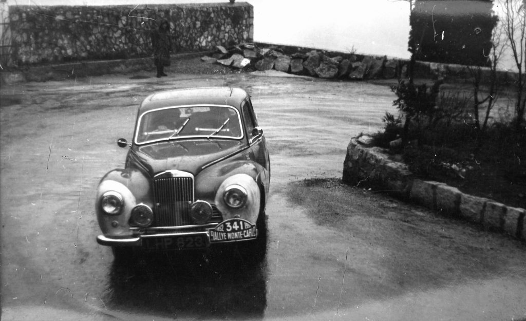 The Moss/Scannell/Cooper Sunbeam Talbot starts the climb into the mountains at the start of the last stages of the Monte Carlo Rally 1952. Note the white-washed front wings to identify the competing cars for the benefit of the marshals