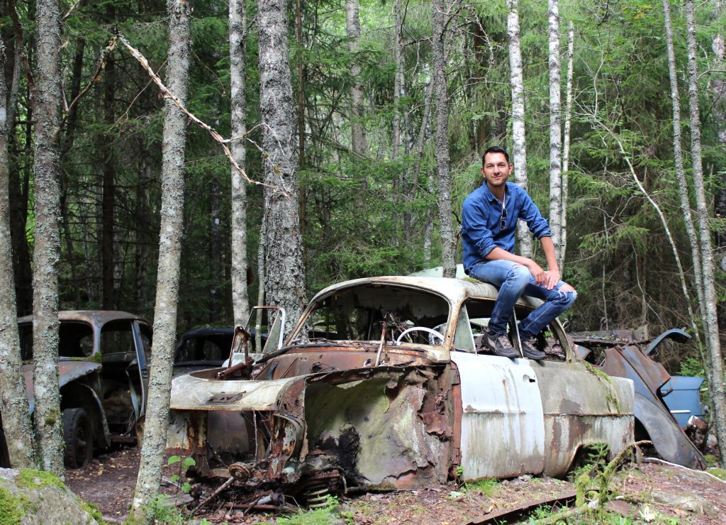 Philipp in a "car cemetery" in Sweden