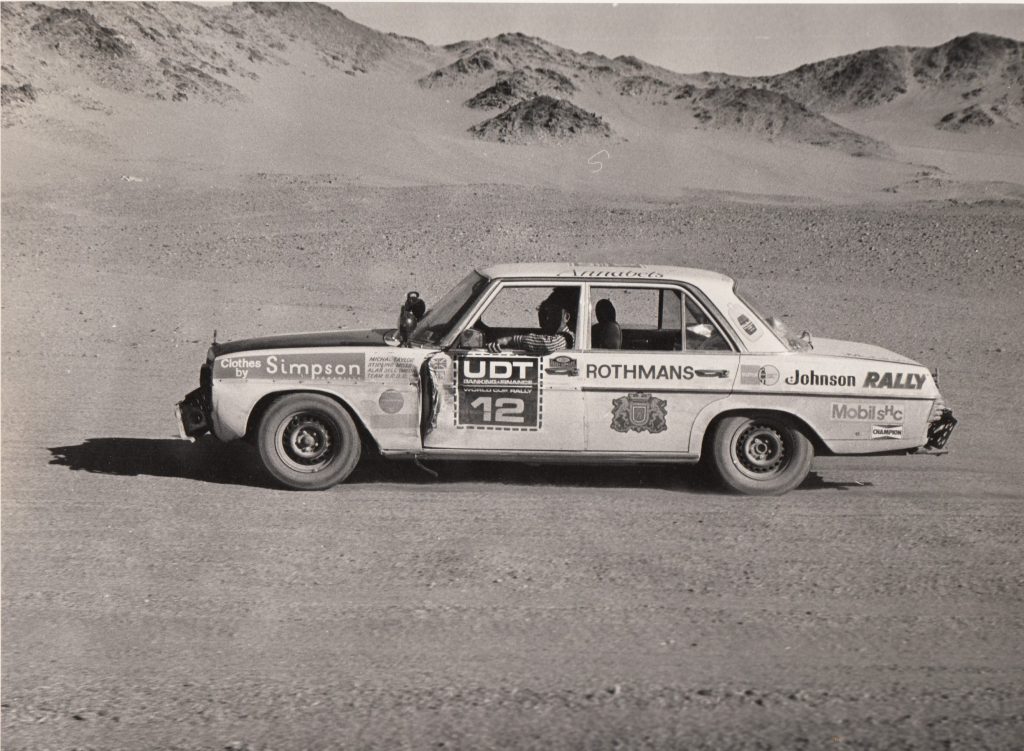 A second-hand looking Mercedes Benz of Moss/Taylor/Sell in the Sahara Desert after the team had been rescued. Sell was in one fop the Land Rovers recovering.   