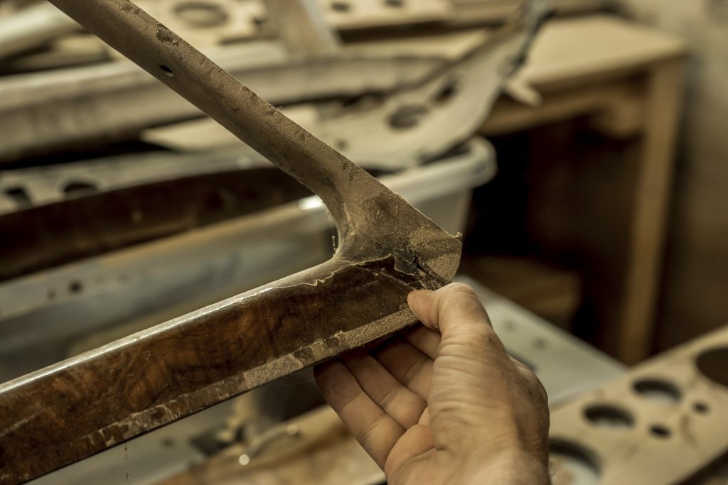 Worn veneer on wood trim before restoration