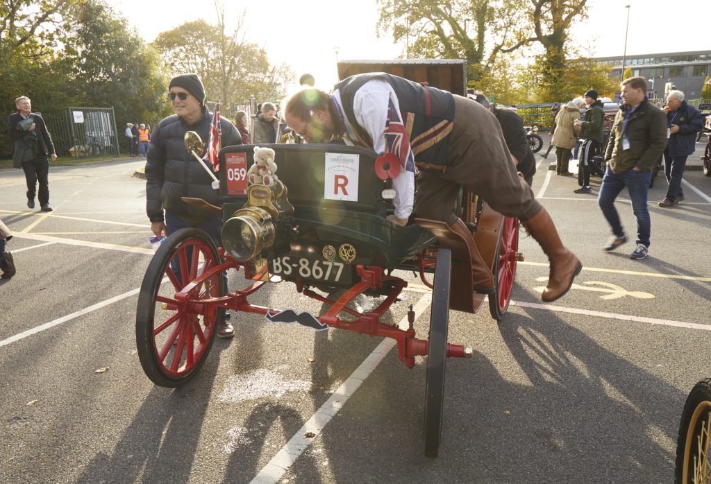 Checks on a car at the Veteran Car Run