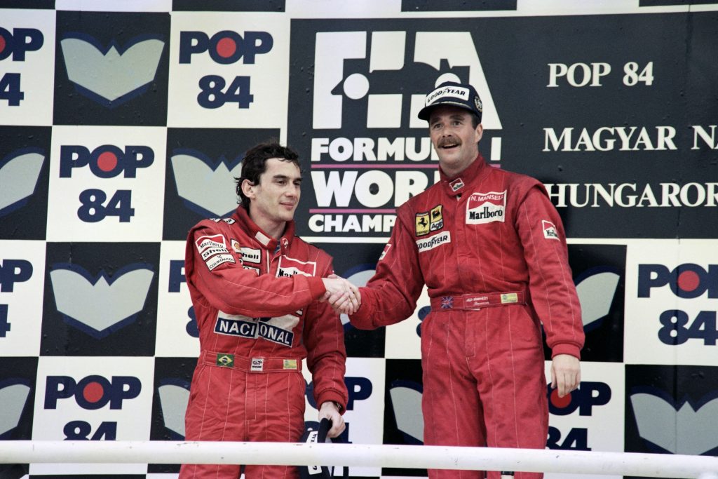 Ayrton Senna and Nidel Mansell shake hands on the podium