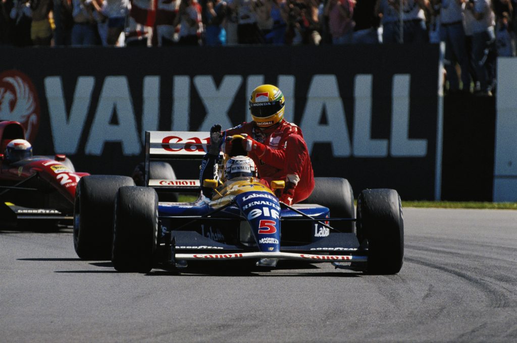 Nigel Mansell gives Ayrton Senna a lift at the 1991 British GP