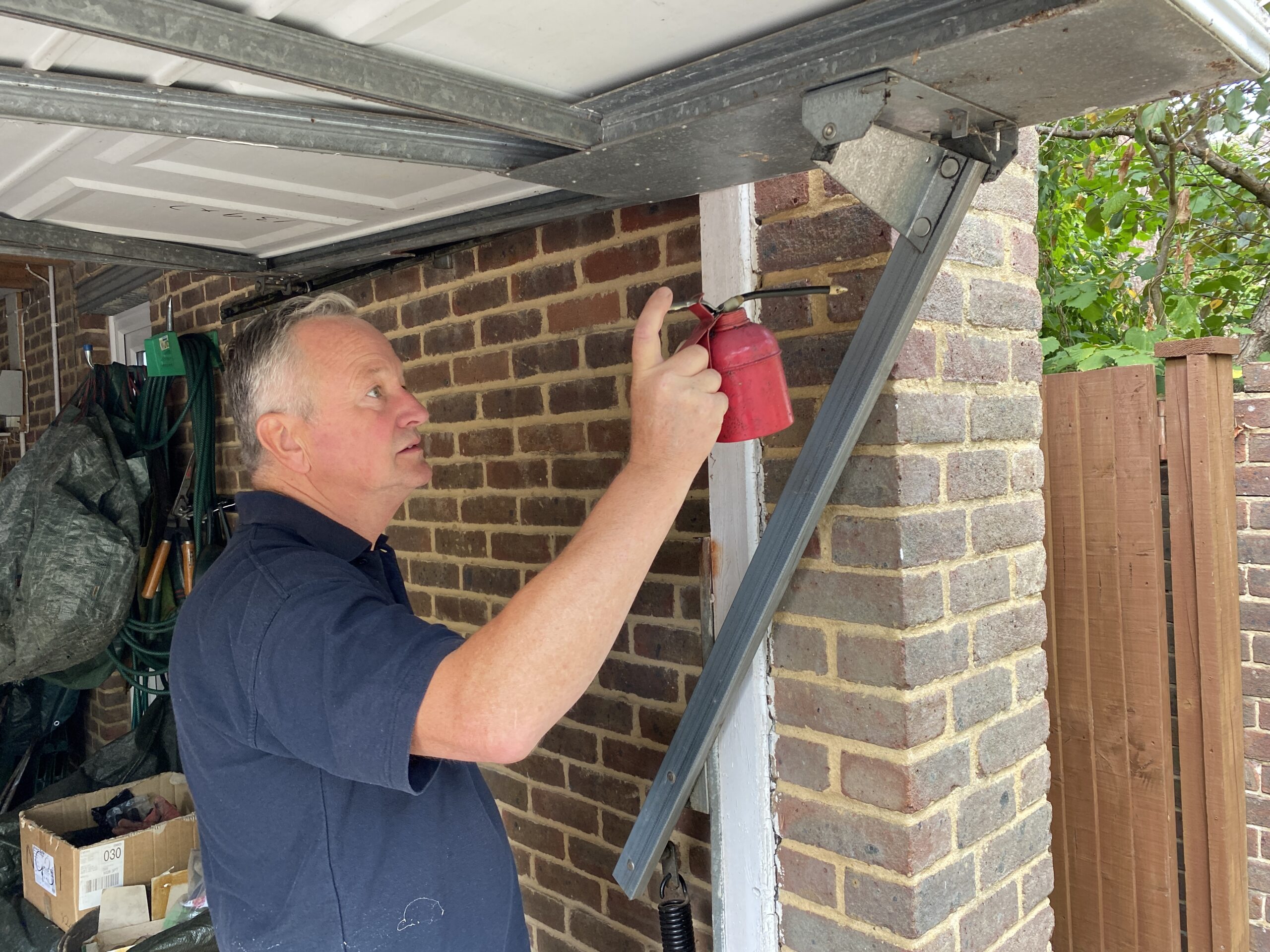 Greasing garage door rails