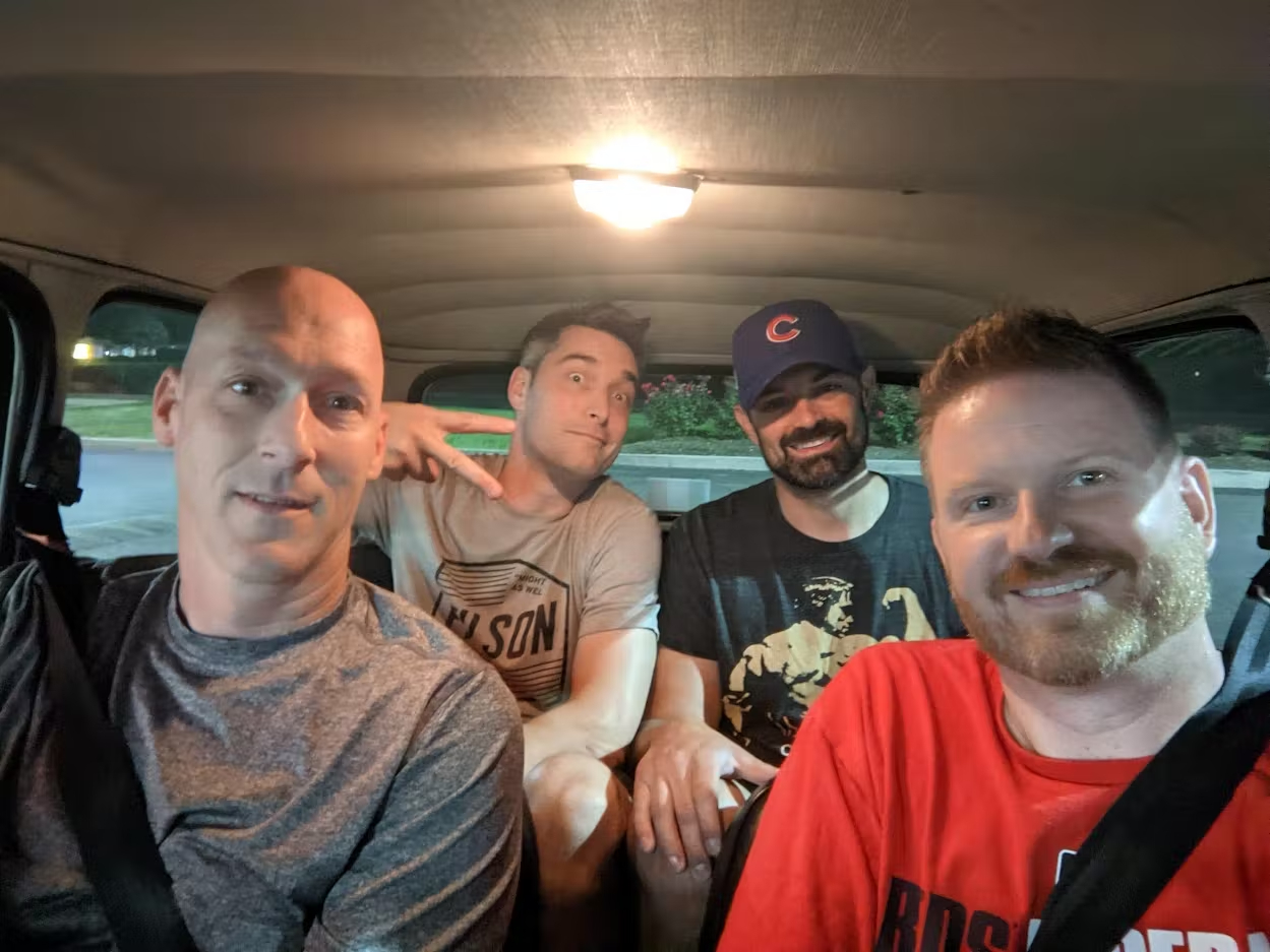 Four adults in a classic Mini