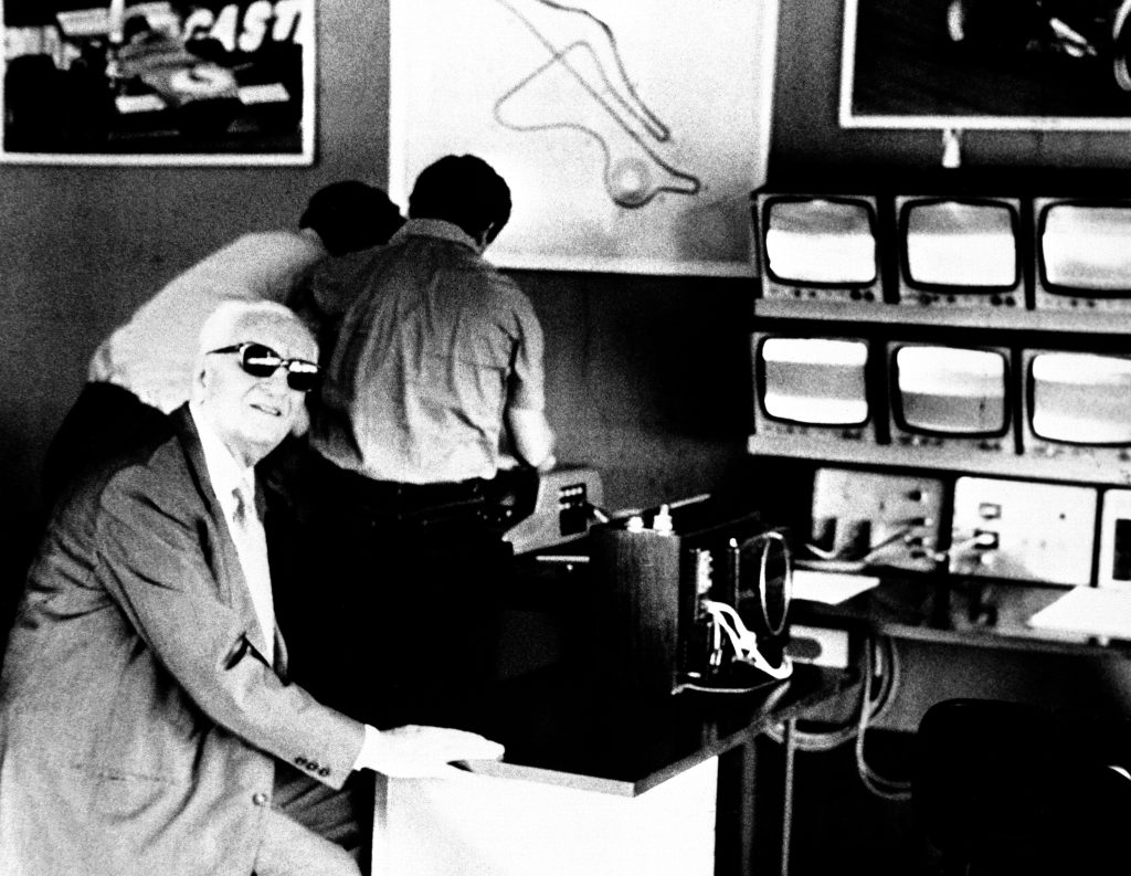 Enzo Ferrari inside his office at the Fiorano farm house, with CCTV monitors