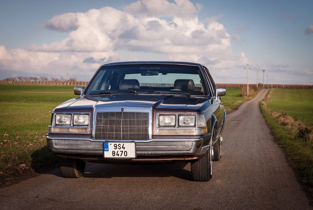 1987-Lincoln-Continental-prague one lane road clouds