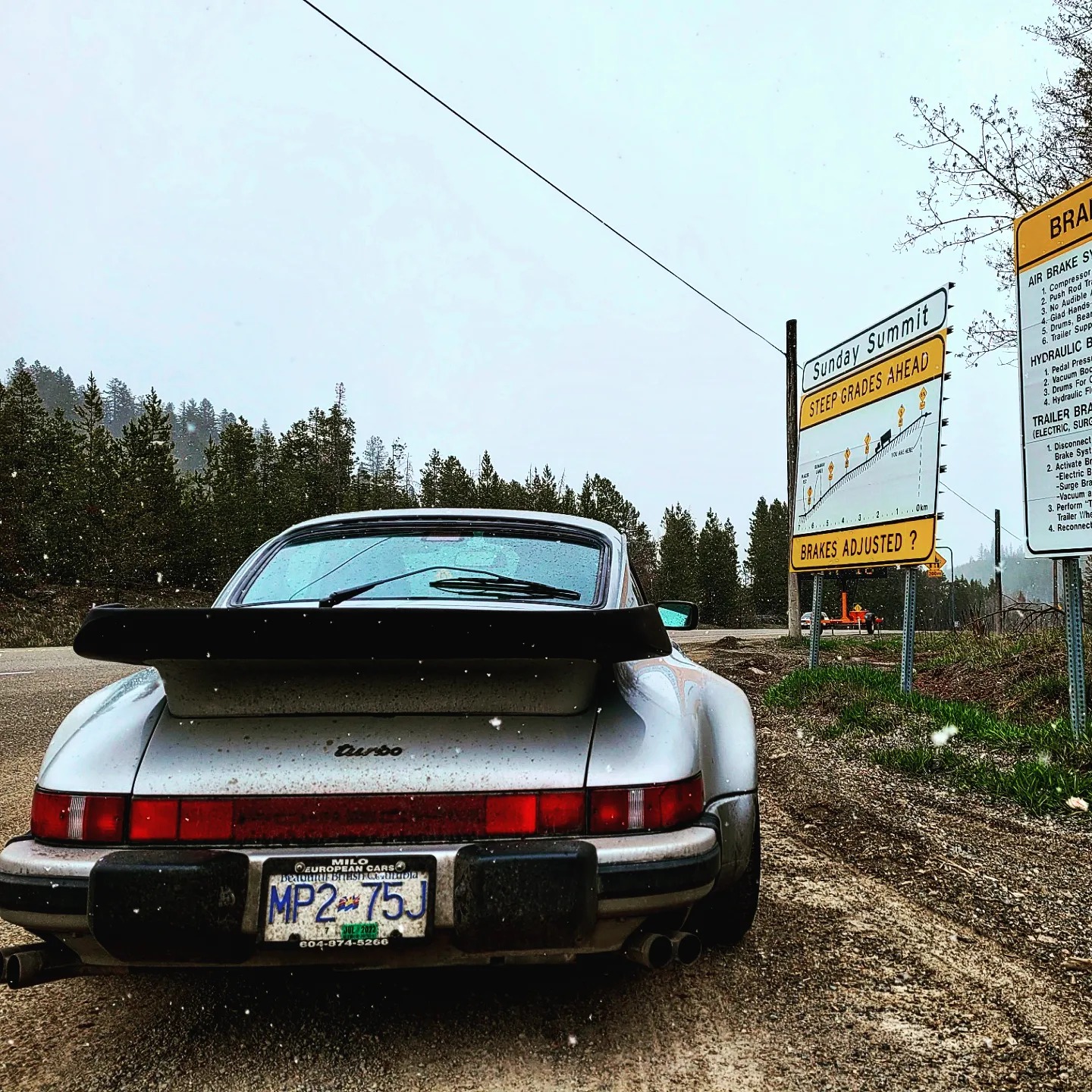 Car Collector Ms Helen Porsche 911 Turbo pull off steep graded road signs