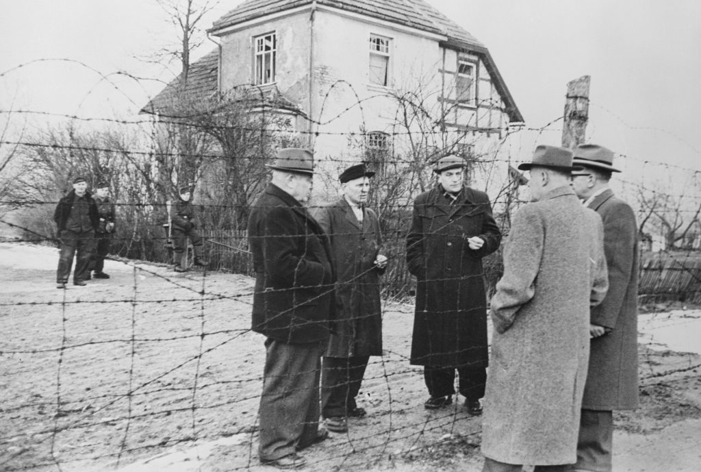 View of Political Officials Talking at Iron Curtain
