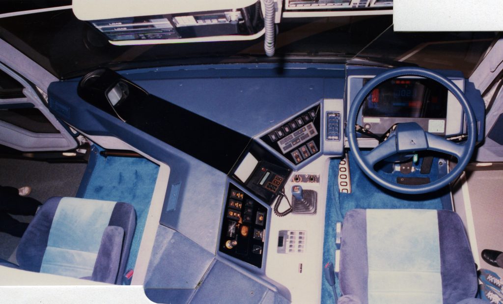 A look down below from the elevated berth, showing the digital gauge cluster, rear view monitor screen, and plenty of other electronic gadgetry