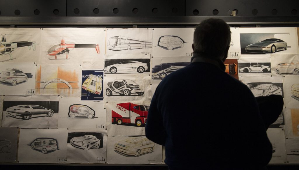 man observing Marcello Gandini's drawings