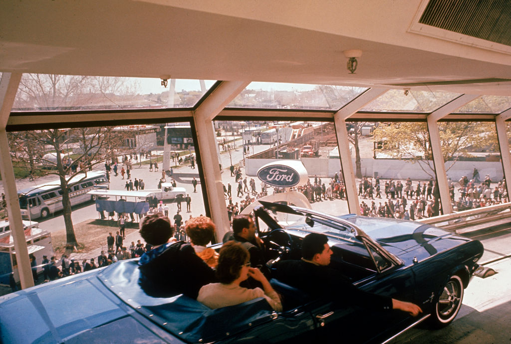 Family riding Ford Mustang at the Ford Motor World's Fair Exhibit