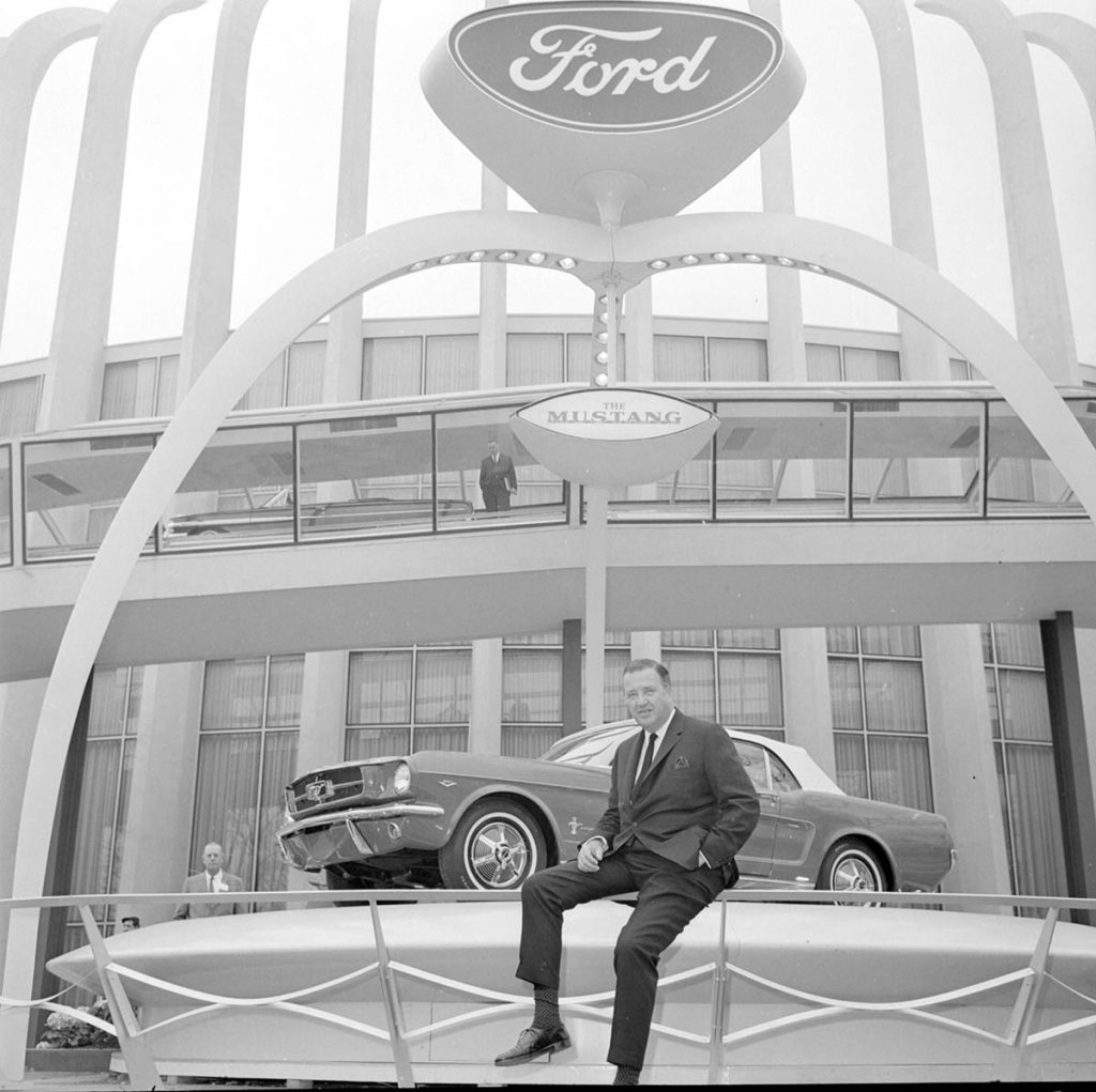 Henry Ford II poses with the all-new Mustang